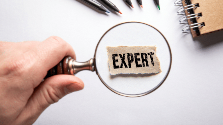 Magnifying glass highlighting the word expert to illustrate when business owners should call an HR expert